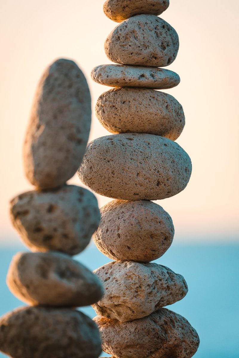 Stack of smooth stones balanced against a soft sky